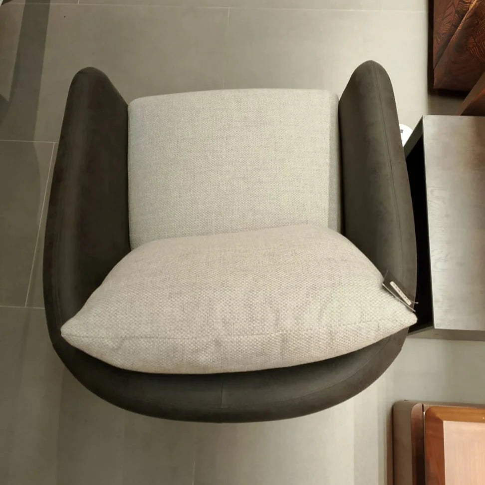 Tesla Armchair display model by SALONI, featuring modern design with sleek lines and plush upholstery.