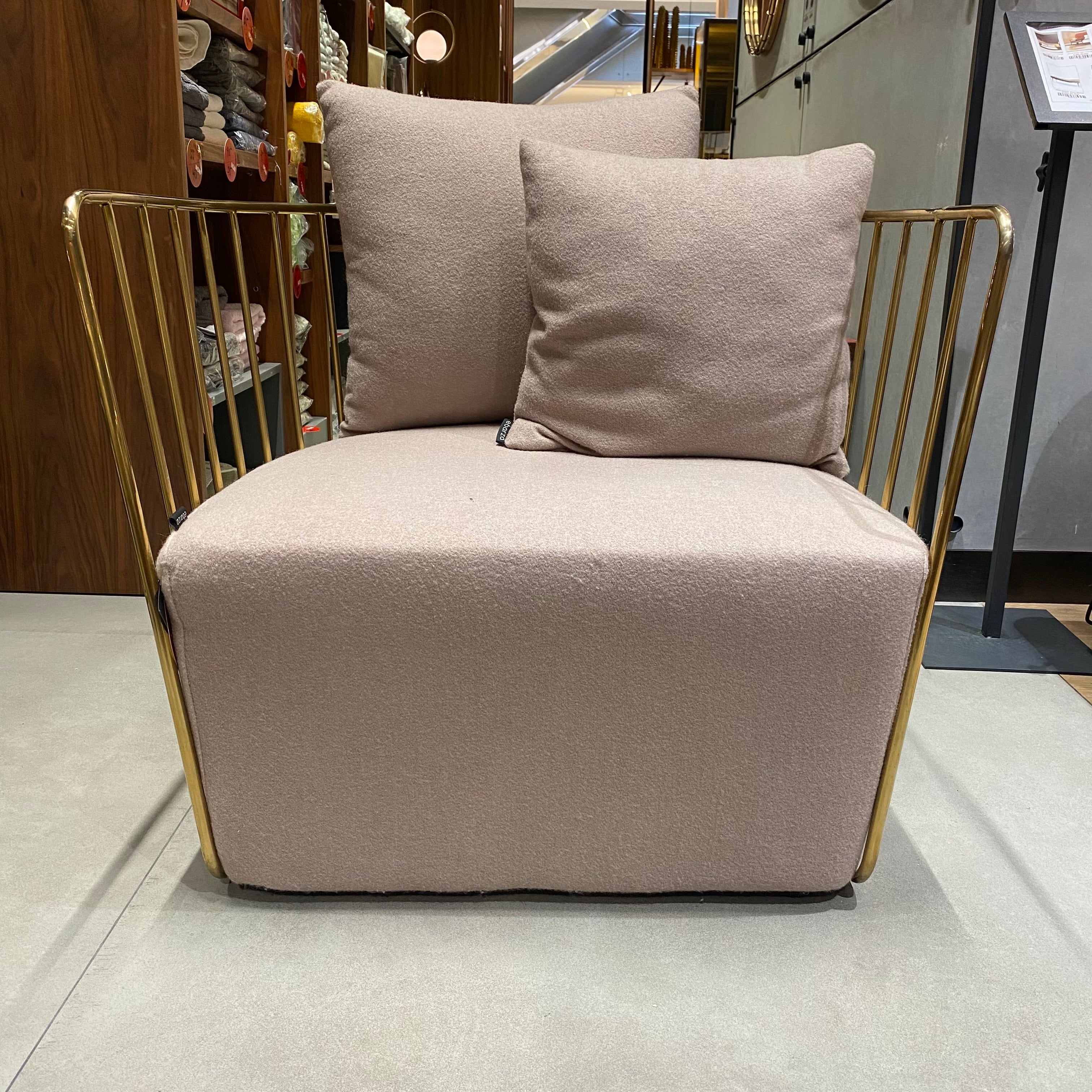 Display of Torino stainless steel armchair by Beacon, showcasing modern design with sleek metal frame and comfortable upholstery.