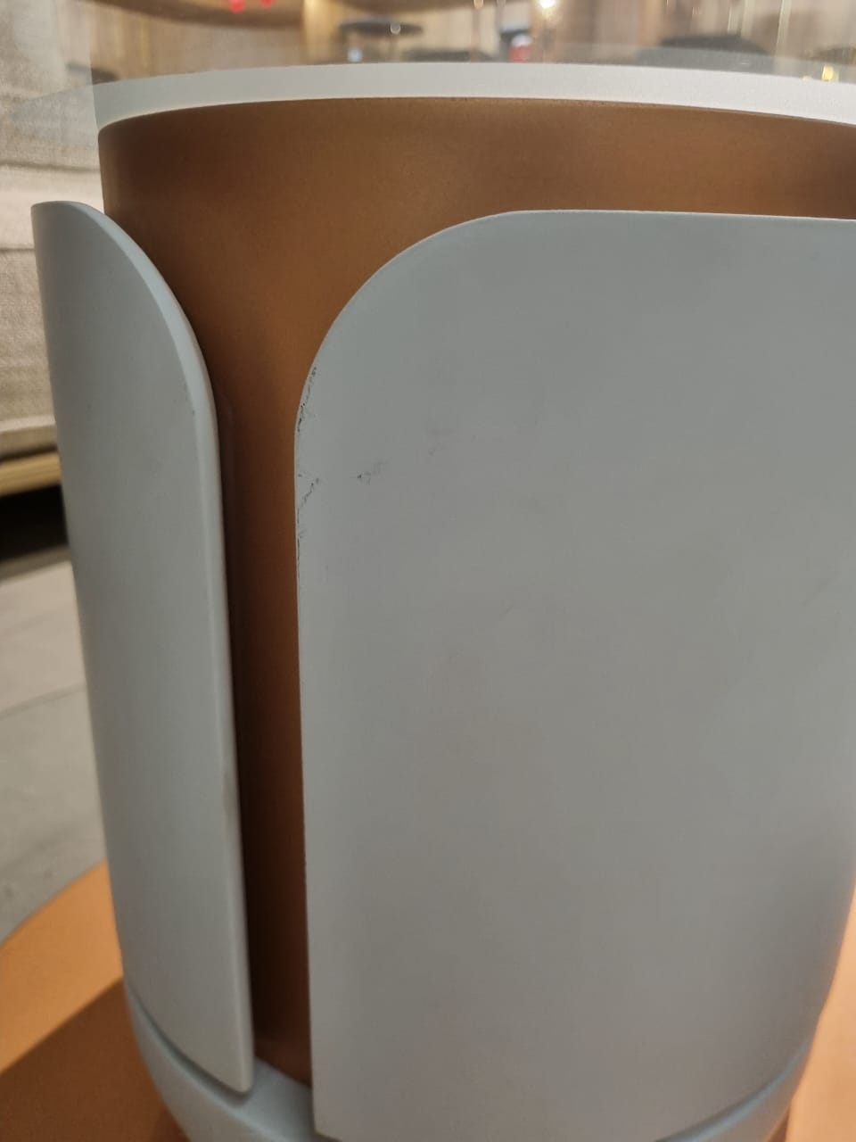 Loda Furniture Tulip coffee table display item with a sleek, modern design and smooth surface, shown in a retail setting.