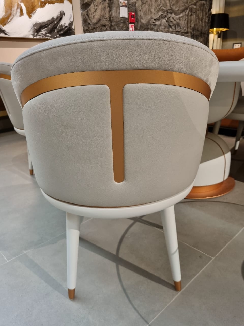 Display image of a Tulip Dining Chair by LODA Furniture, showcasing its modern design and smooth, curved seat with four legs.