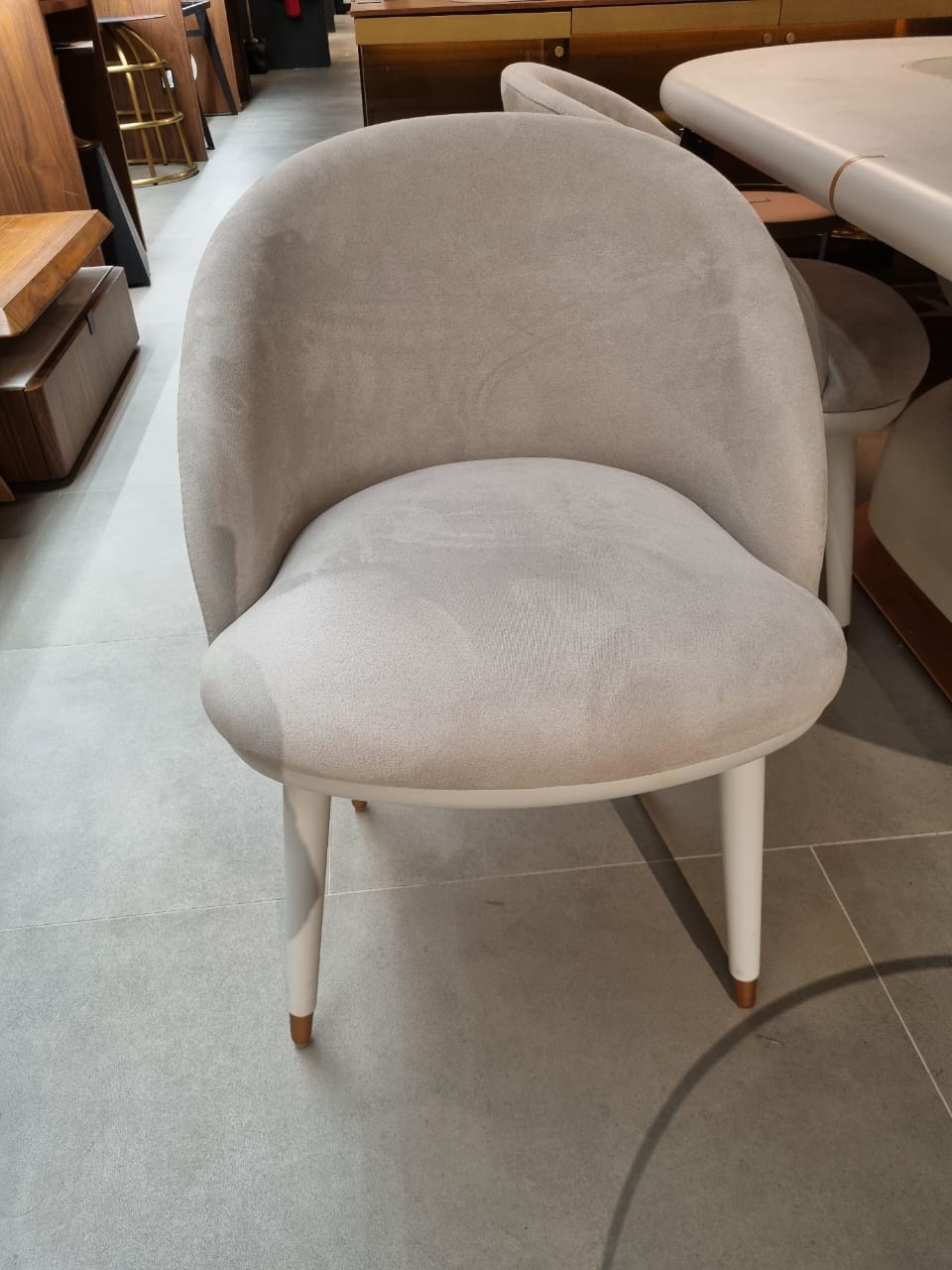 Display of a Tulip dining chair by LODA Furniture, showcasing a modern chair with a curved seat and sleek design.