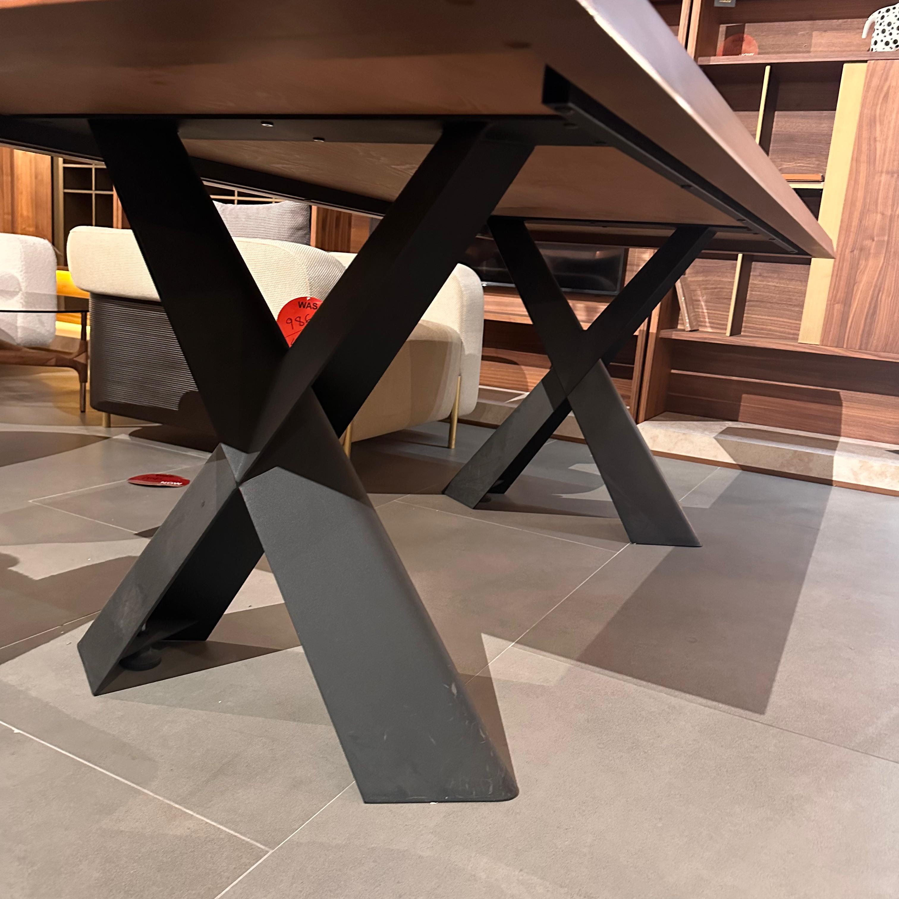 Display piece of the Genova dining table by YOL LIVING, showing a sleek wooden table with a modern design.