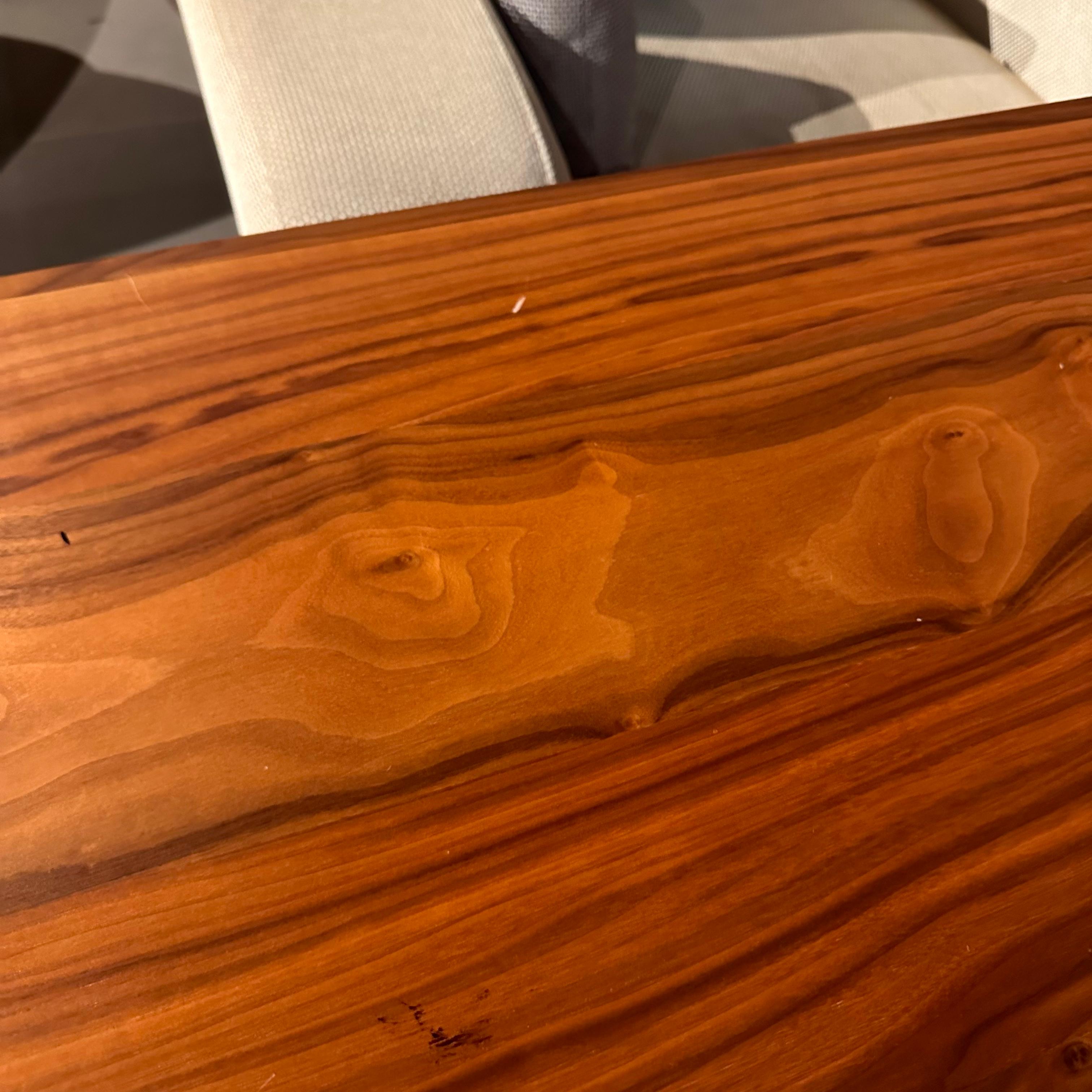 YOL LIVING Genova Dining Table display piece showing a sleek wooden table with a modern design and natural finish.