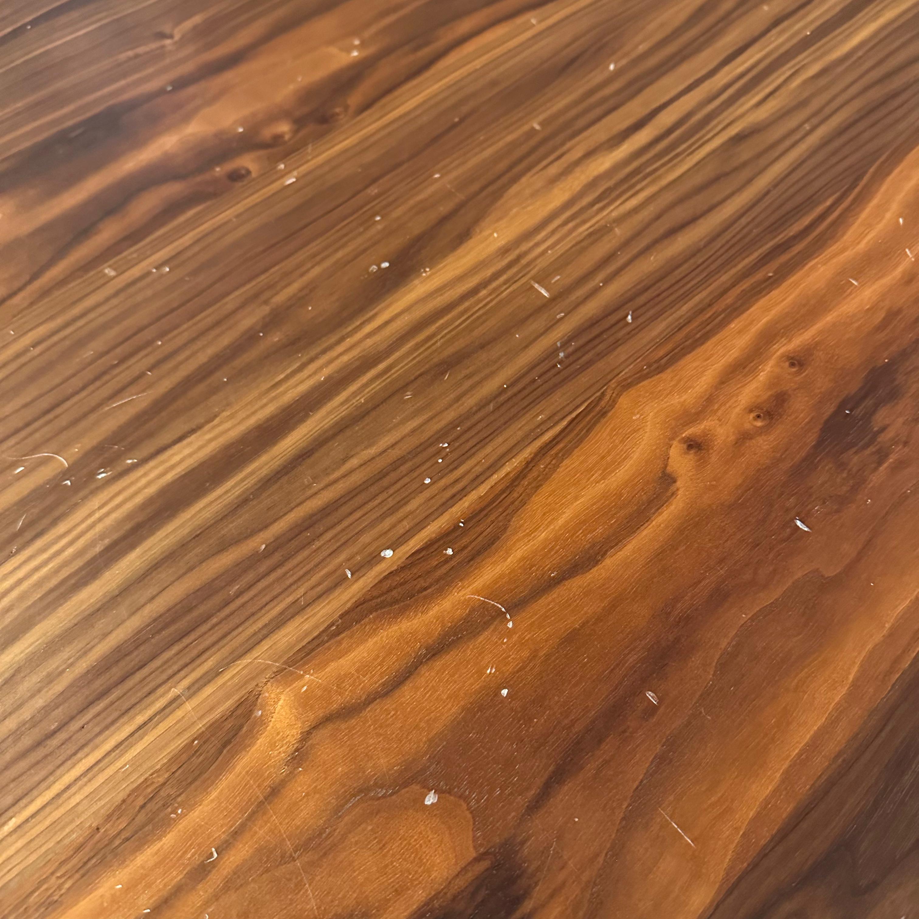 Display piece of the Genova Dining Table by YOL LIVING, showcasing the wooden tabletop and modern design.
