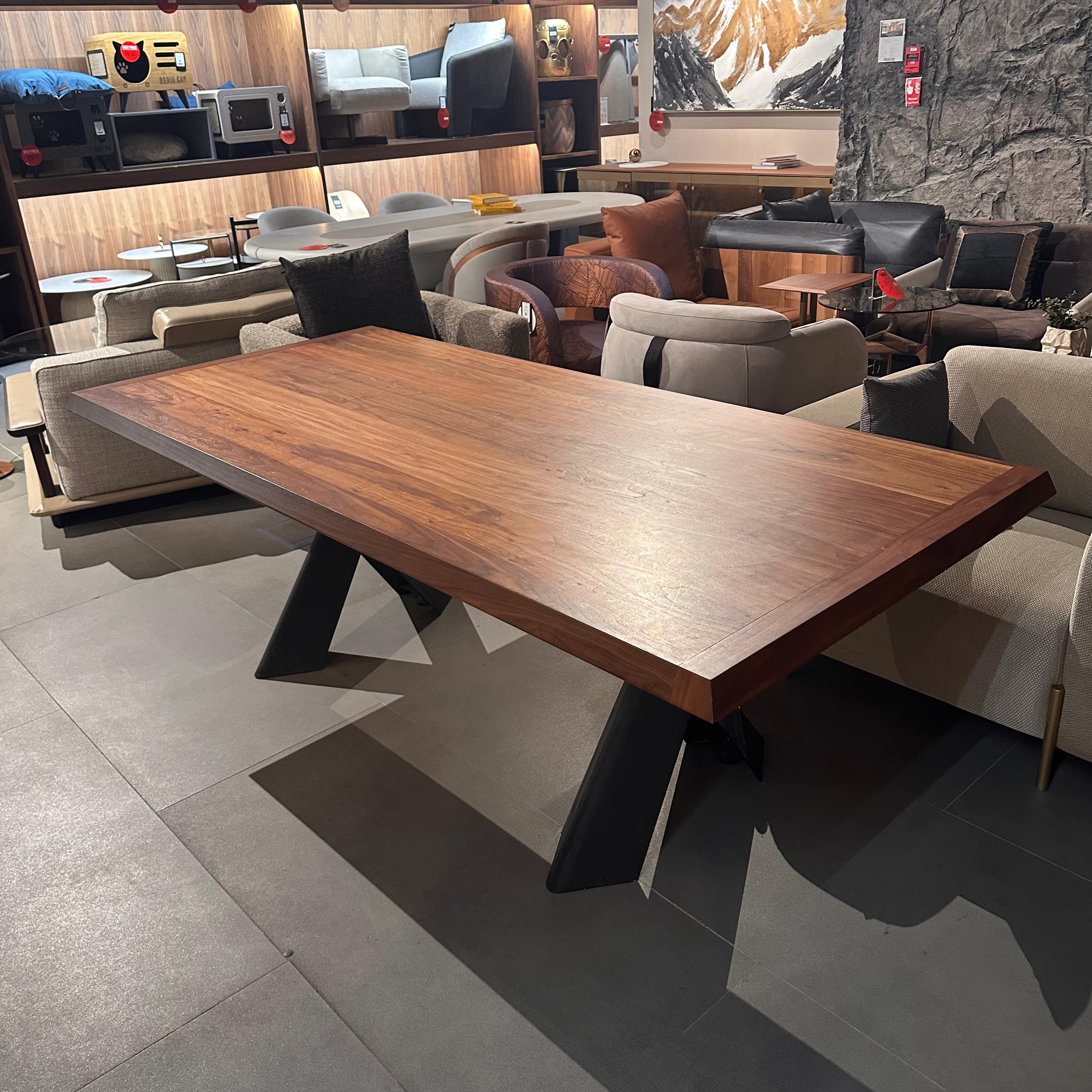 Display piece of the Genova Dining Table by YOL Living, showcasing the table's wooden surface and modern design.