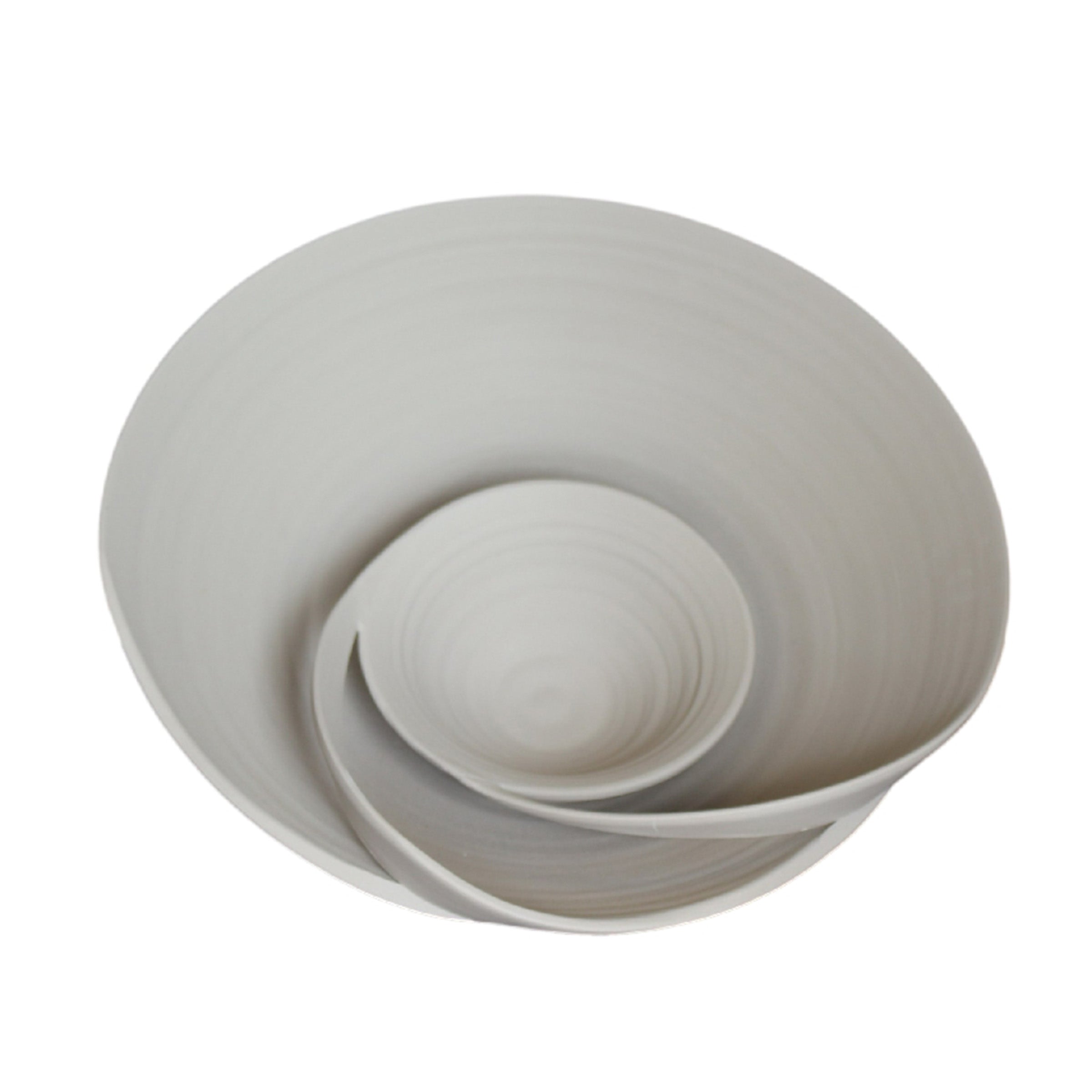 Dreamy beige ceramic bowl from BEACON, perfect for serving or decorative use, with smooth rounded edges and a glossy finish.