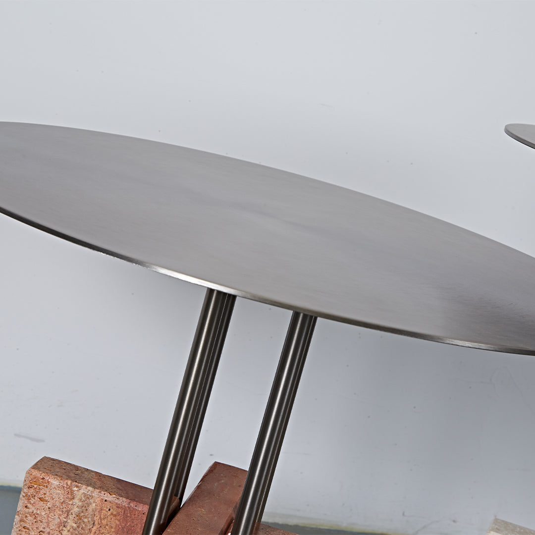 Elysian Travertine Side Table by BEACON featuring a sleek design with natural travertine surface and modern metal legs.