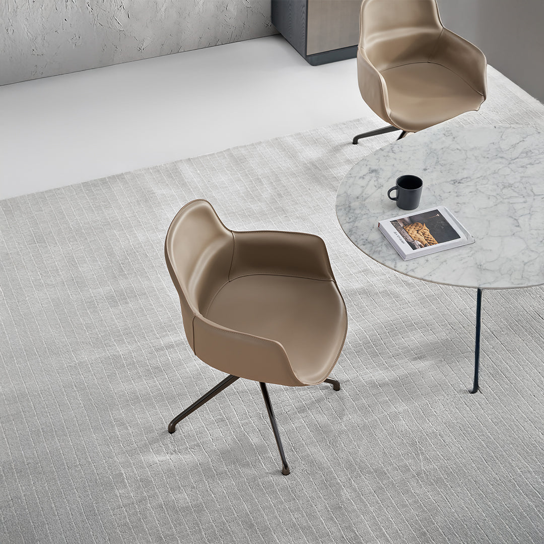 Equus Contour beige saddle leather dining chair by BEACON with a sleek, modern design and comfortable seating.