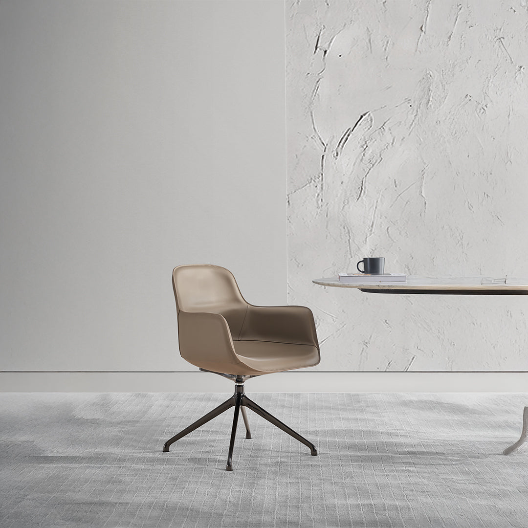 Beige saddle leather dining chair with contoured seat and wooden legs, designed by BEACON for comfortable seating.