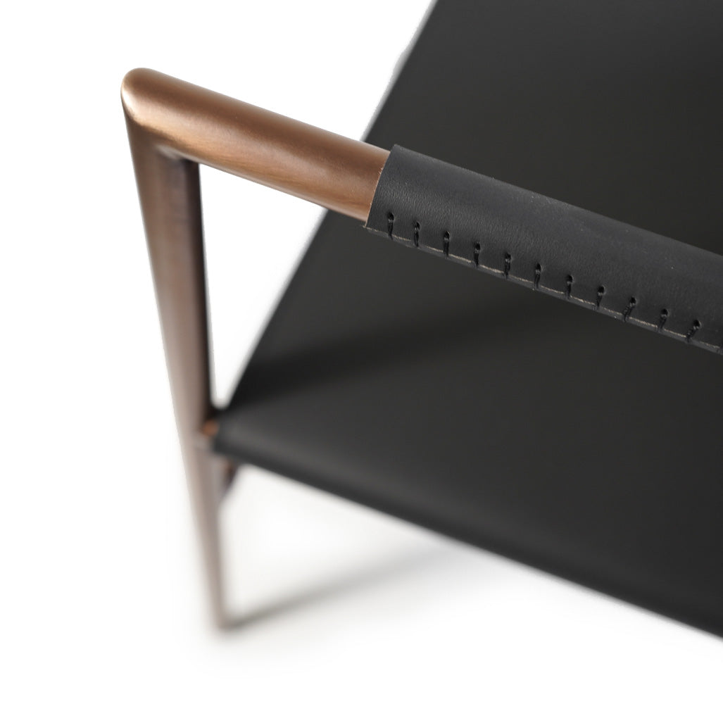 Dark gray Eugene lounge chair by BEACON with sleek modern design, featuring cushioned seat and backrest for comfortable seating.