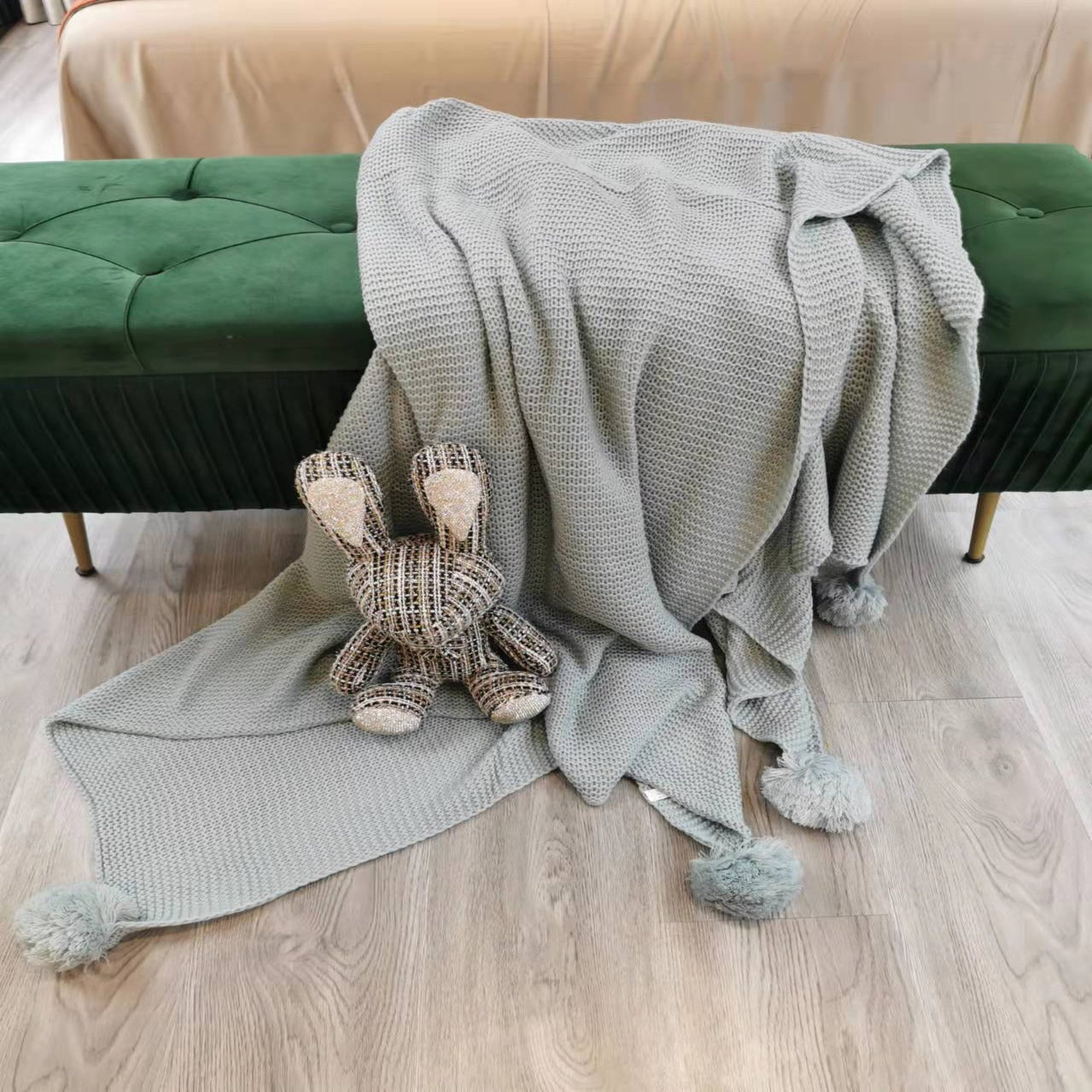 Blue Four Corner Pompom Blanket by BEACON, soft and cozy blanket with pompom accents in each corner.