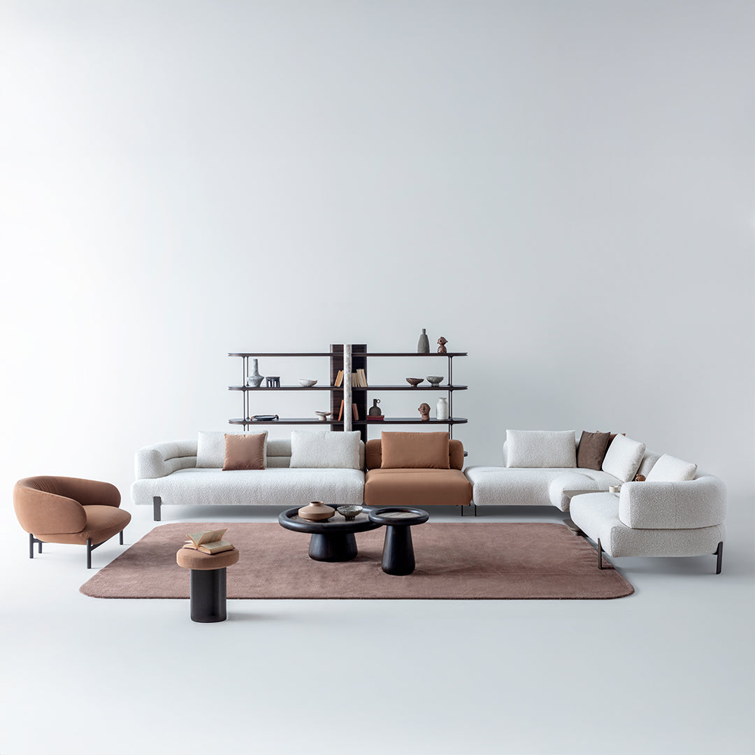 Display of HOMAGE KOLTUK Freda corner sofa in a modern living room setting, showcasing beige fabric upholstery and plush cushions.