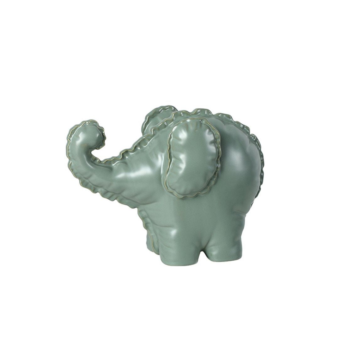Cute ceramic elephant figurine by BEACON, perfect for home decor, showcasing a playful and charming design for any space.