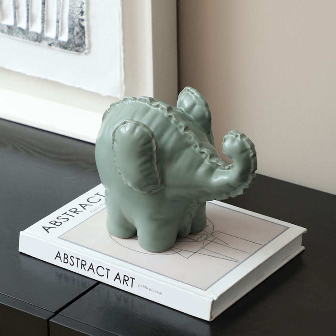 Cute ceramic elephant figurine by BEACON, perfect for home decor, showcasing a playful and charming design for decorative spaces.