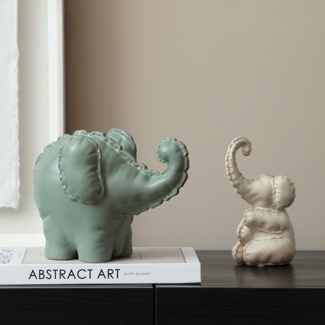 Cute ceramic elephant figurine by Beacon, perfect for home decor, featuring a whimsical design and detailed craftsmanship.