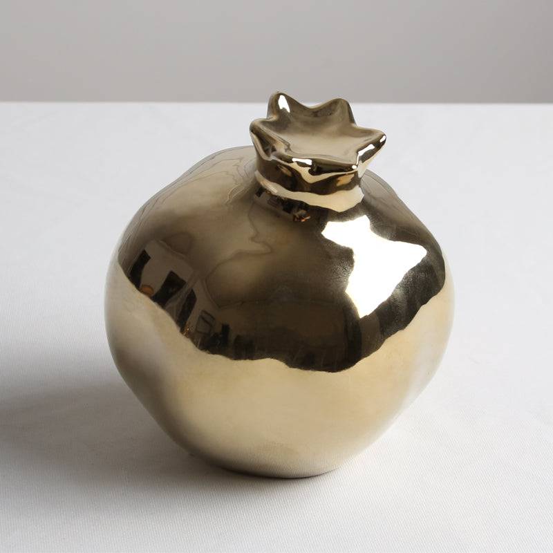 Golden pomegranate home decor figurine by BEACON, decorative metal sculpture for stylish interior accents.
