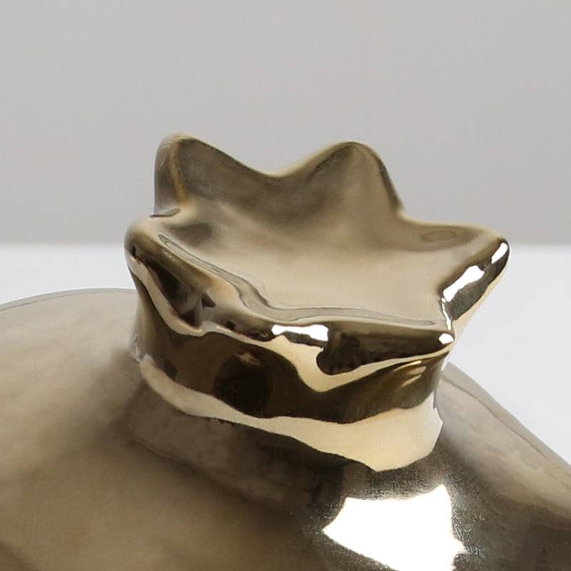 Golden pomegranate home decor figurine from BEACON, decorative piece for stylish interior accents.