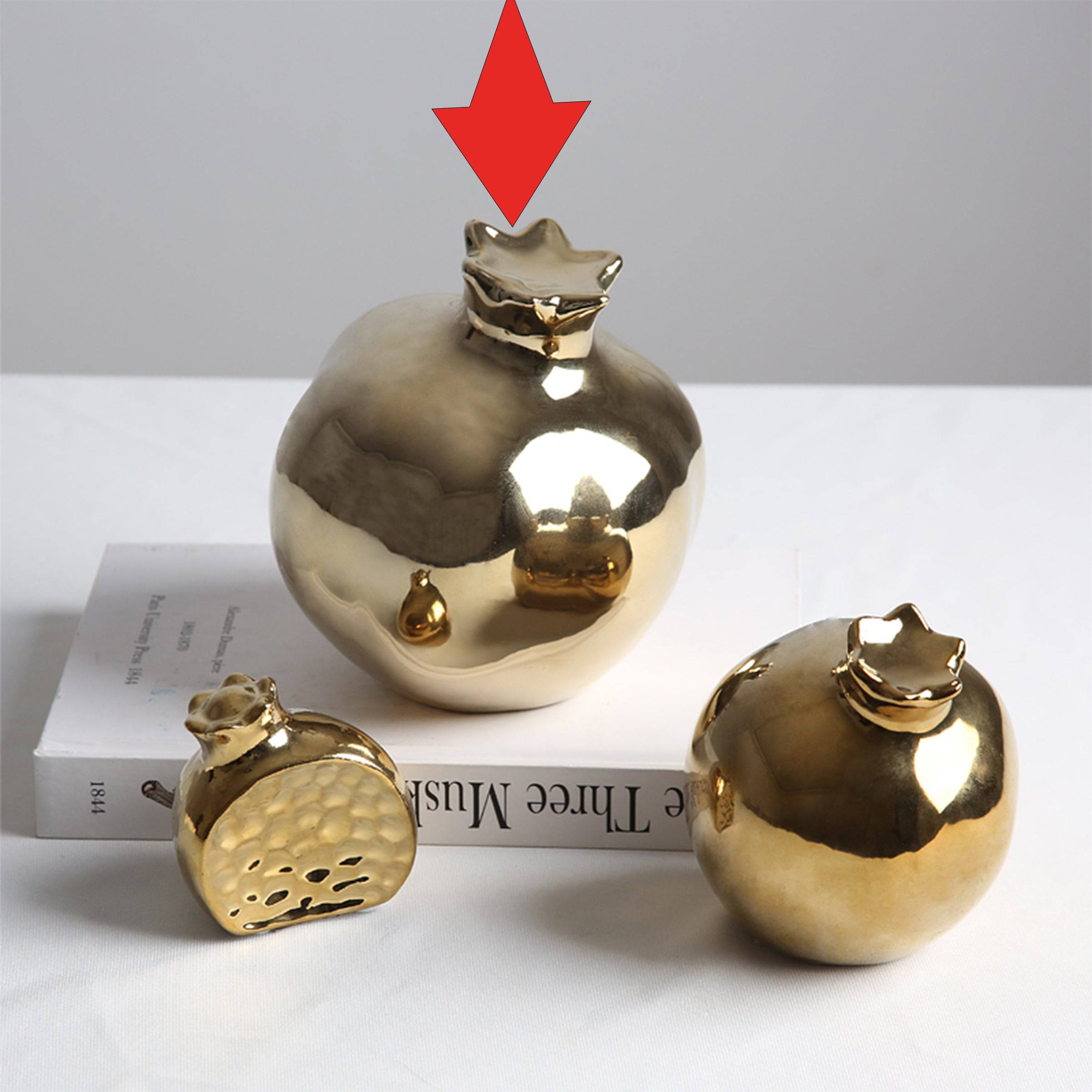 Golden pomegranate home decor figurine by BEACON, decorative gold-colored fruit sculpture for interior decoration.