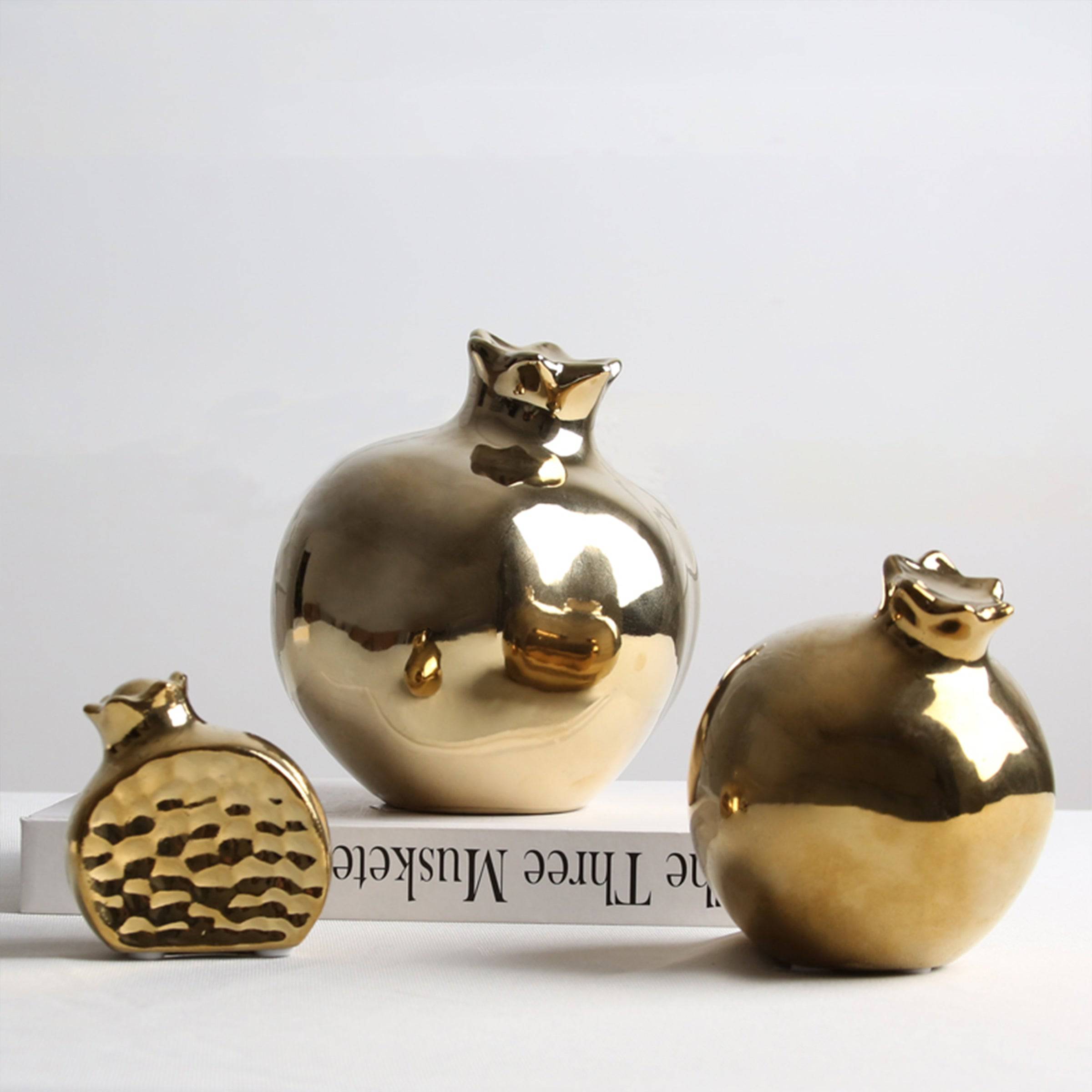 Golden pomegranate home decor figurine by BEACON, decorative accent piece for stylish interior decoration.