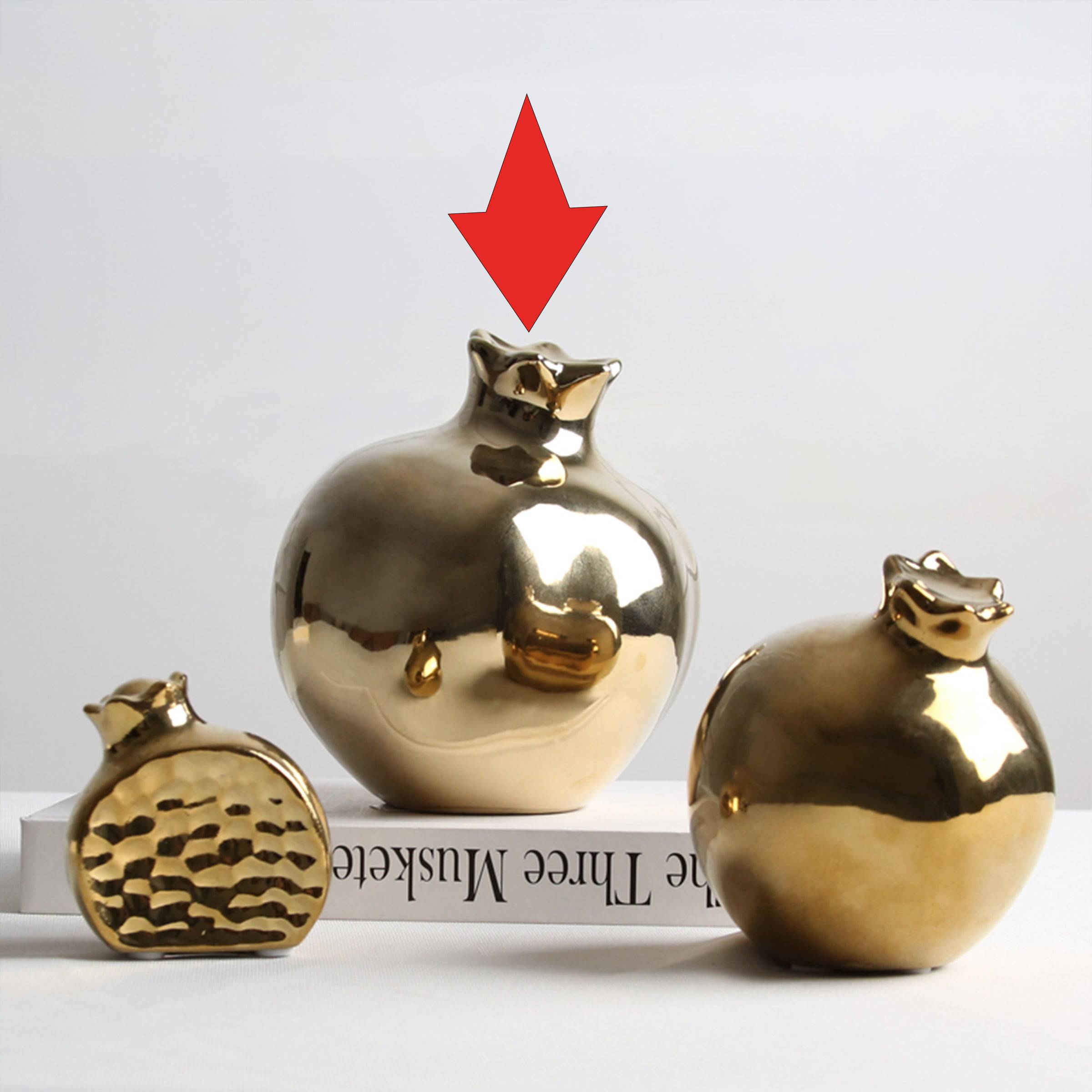 Golden pomegranate home decor figurine by BEACON, decorative ornament with a shiny golden finish for interior accents.