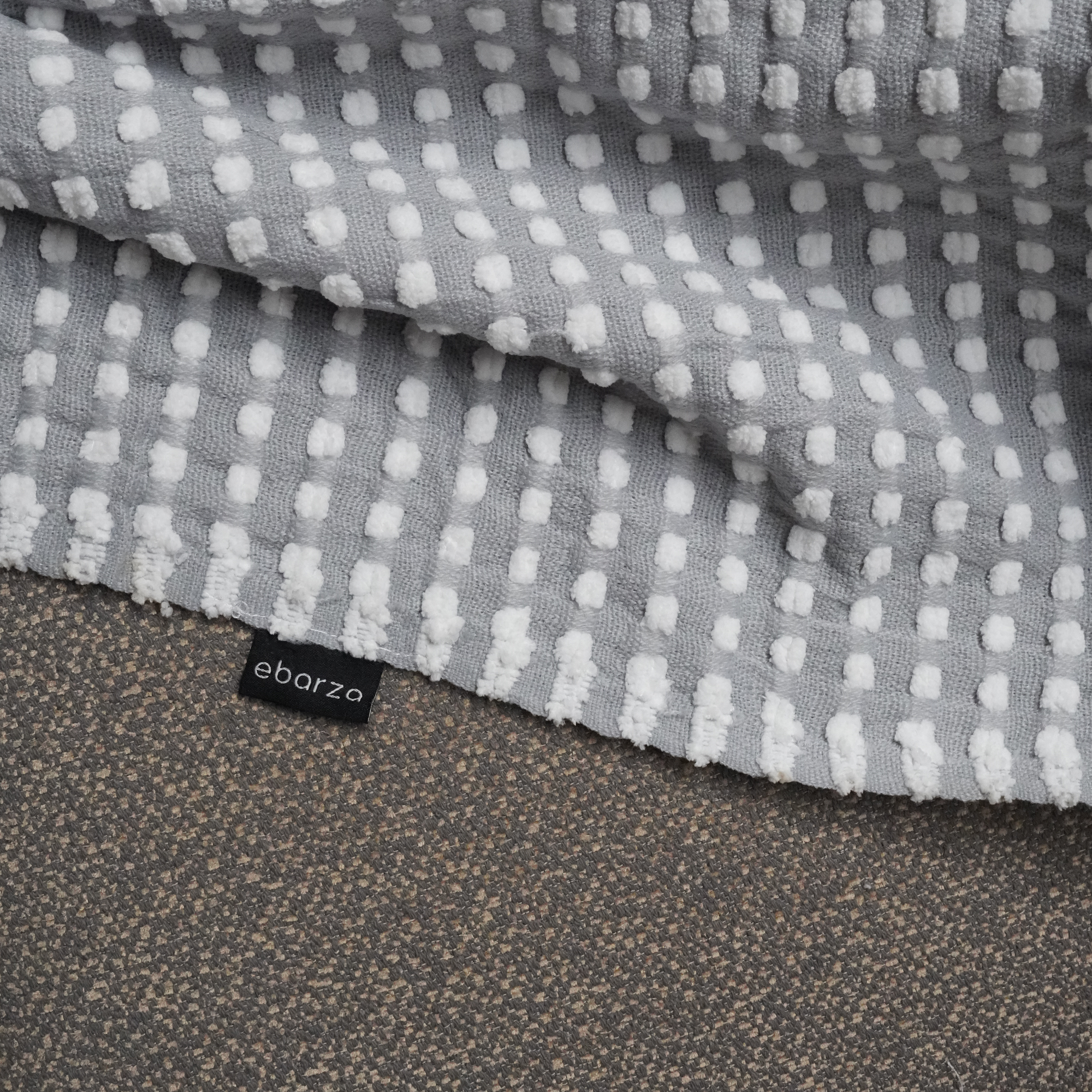 Handmade gray throw blanket by BEACON, soft and cozy with textured weave, perfect for living room or bedroom decor.