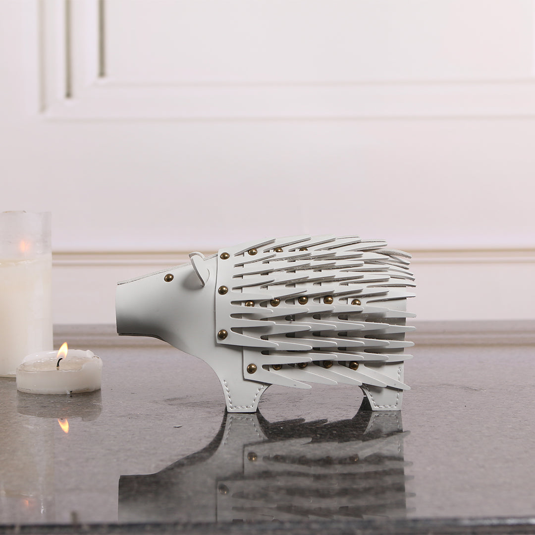Beige ceramic hedgehog-shaped vase sculpture with textured details, designed by BEACON for decorative home use.