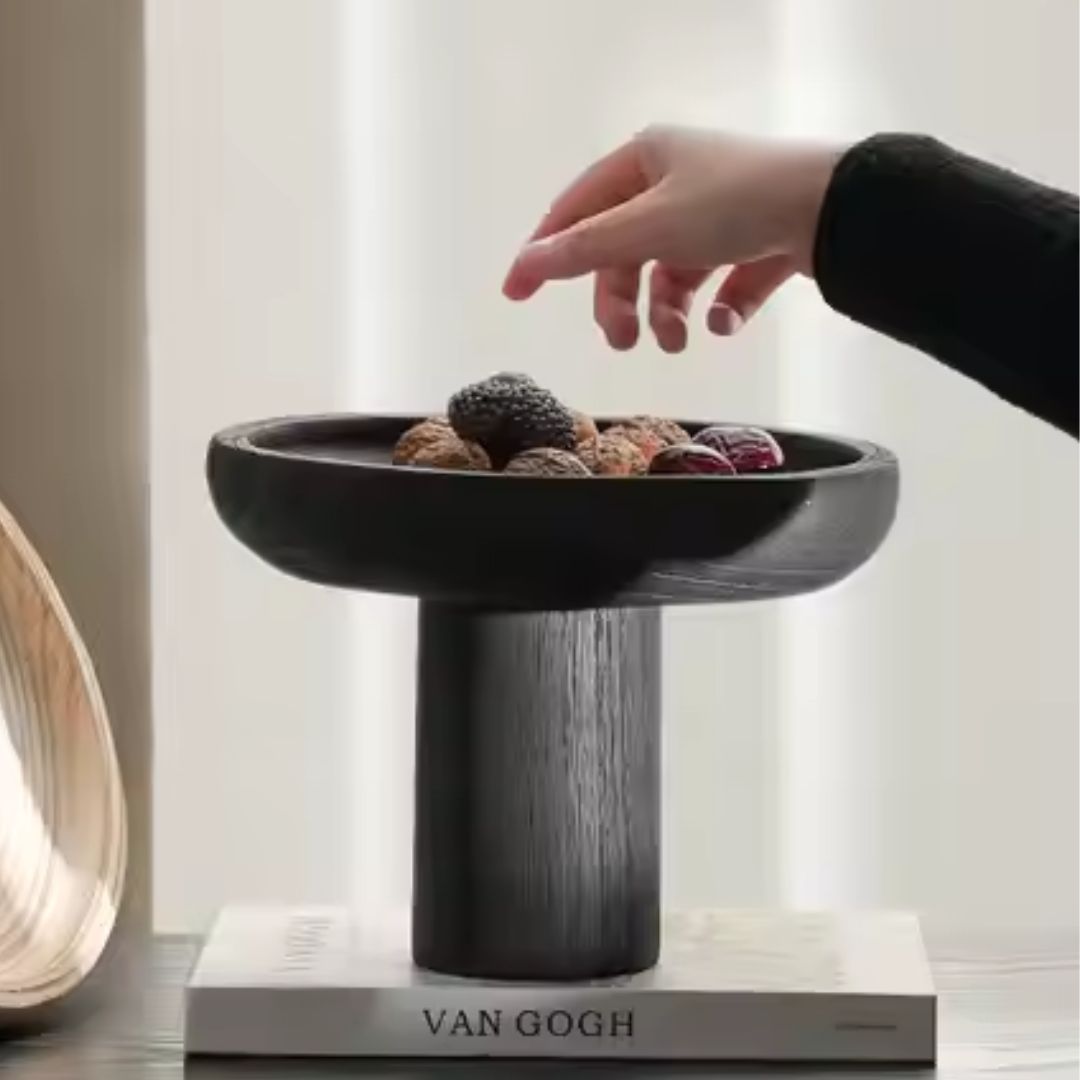 Black high-legged wooden fruit bowl by BEACON, stylish bowl with elevated design perfect for displaying fruit.