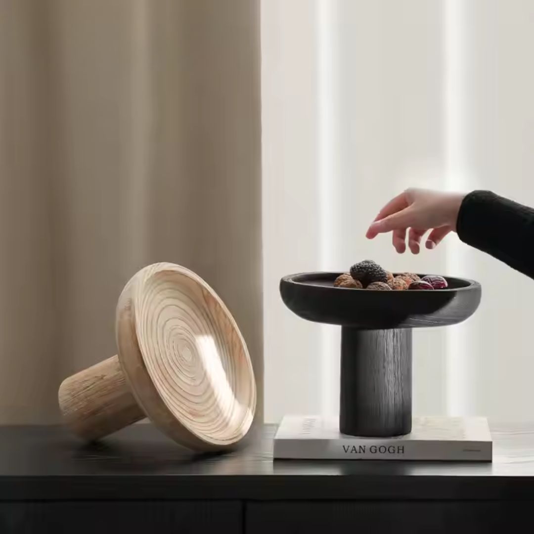 Black high-legged wooden fruit bowl by BEACON, featuring a sleek design and sturdy stand for elegant fruit display.