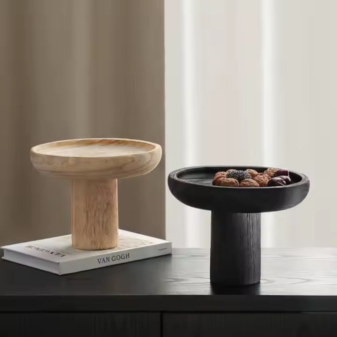 Black high-legged wooden fruit bowl by BEACON, designed for holding fresh fruit with a modern, elegant look.