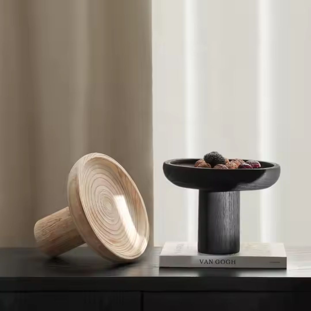 Black high-legged wooden fruit bowl by BEACON, stylish bowl with elevated design perfect for displaying fruit.