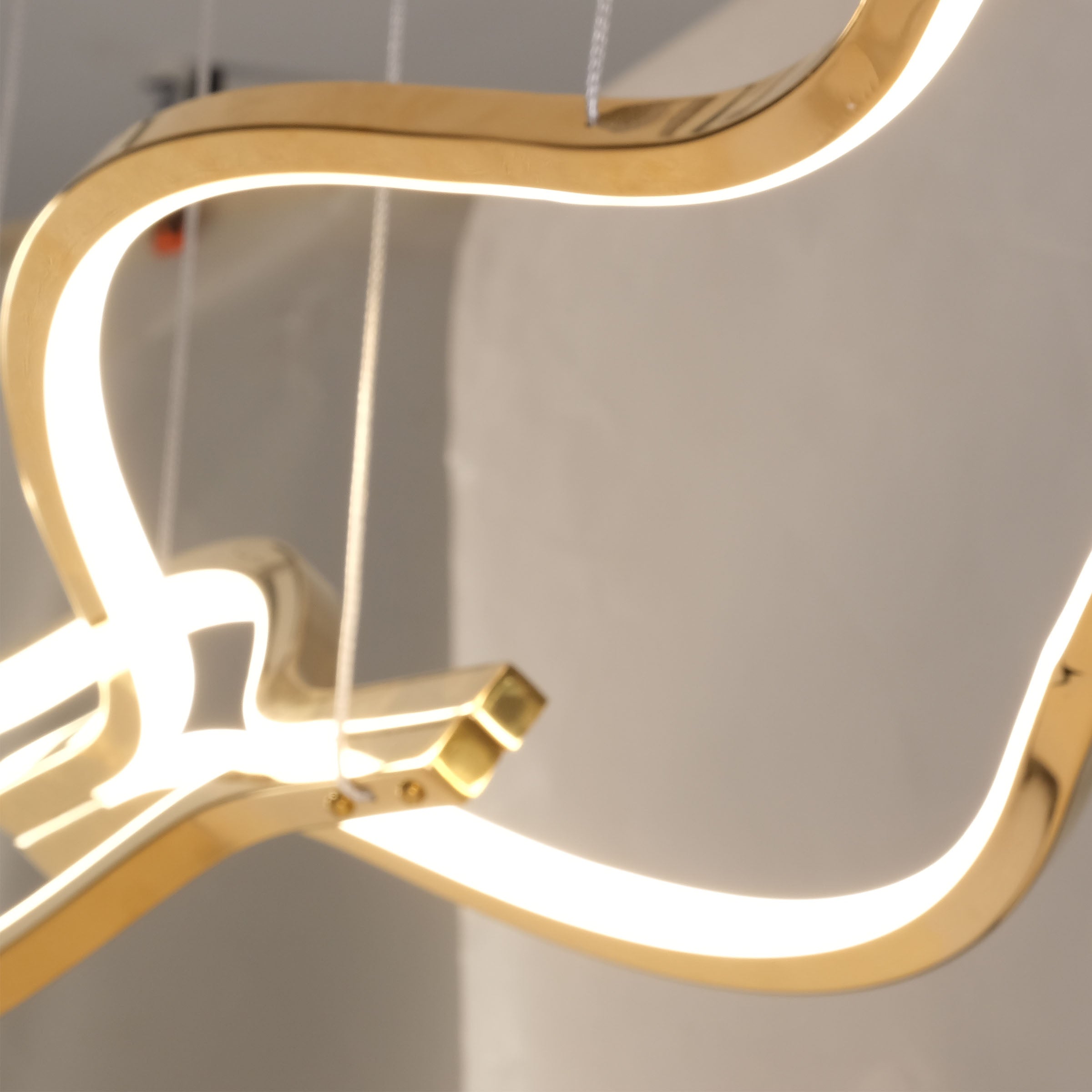 Infinity Orbit stainless steel pendant lamp by BEACON, modern design with sleek, curved lighting element for contemporary interiors.