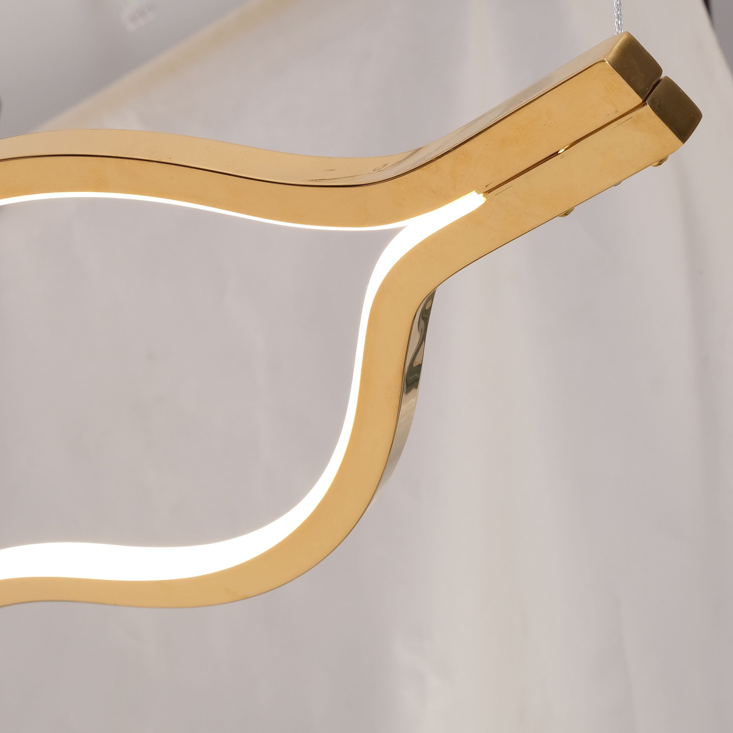 Infinity Orbit stainless steel pendant lamp by BEACON, modern design with sleek curved metal structure for stylish lighting.