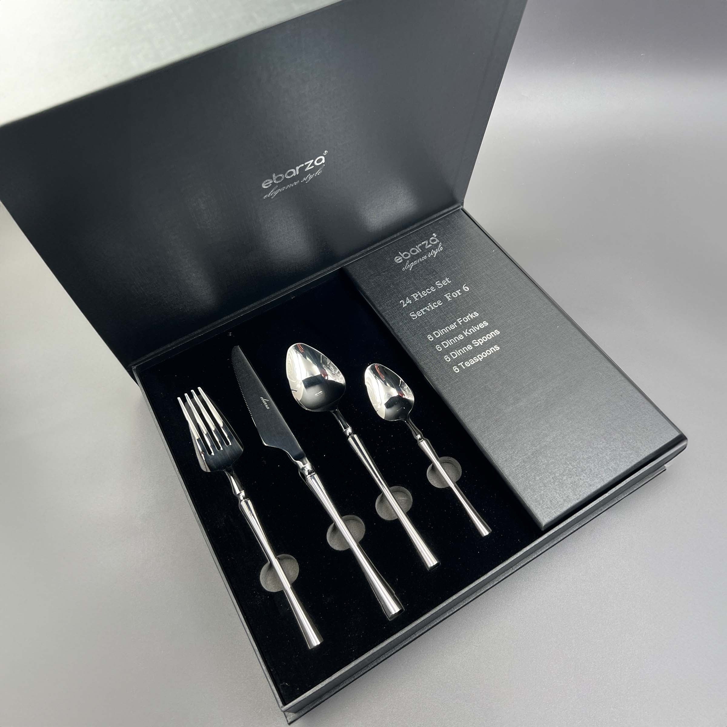 Jance 24-piece mirror silver cutlery set by BEACON, includes forks, knives, spoons, and serving utensils arranged on a table.