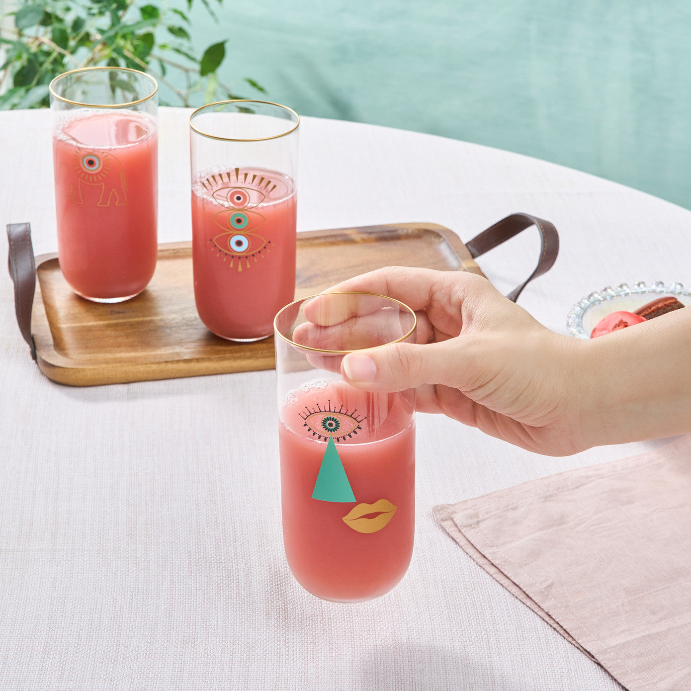 Set of three Karaca Lizzie soft drink glasses featuring clear glass and elegant design, ideal for serving beverages.