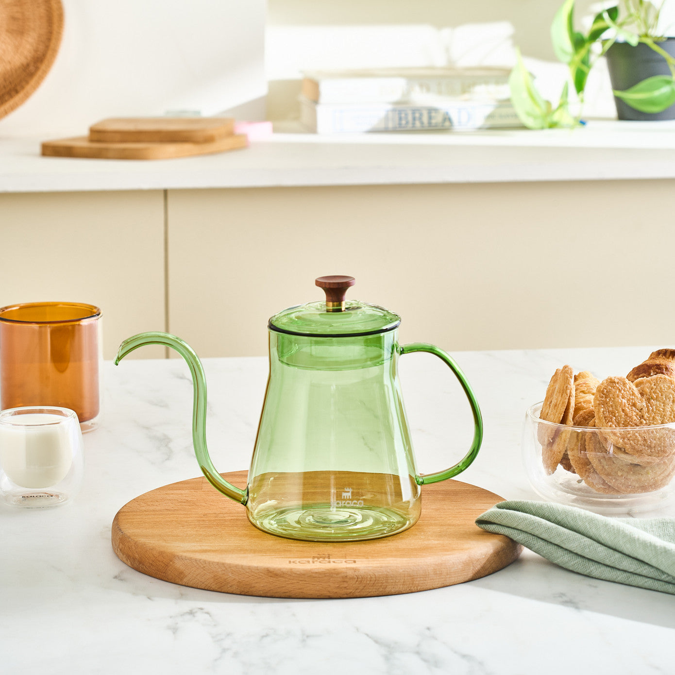 Green Karaca Martina borosilicate glass coffee kettle with 600ml capacity, featuring a sleek design and handle.