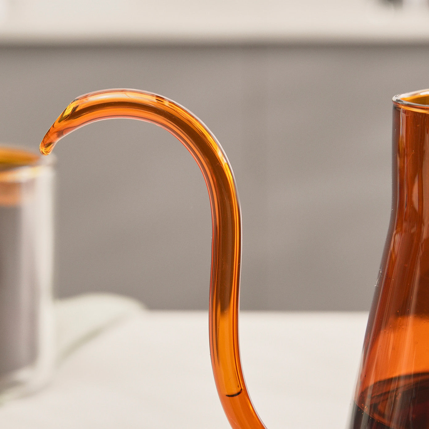 Karaca Martina orange borosilicate glass coffee kettle with 600ml capacity, featuring a sleek handle and spout for brewing tea or coffee.