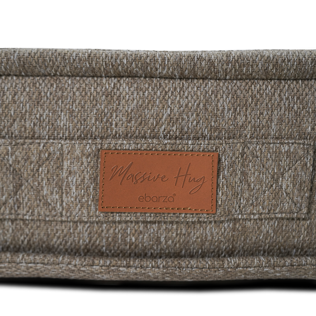 Brown La Concha pouf with compressed foam from BEACON, showcasing its round, cushioned design and textured fabric surface.