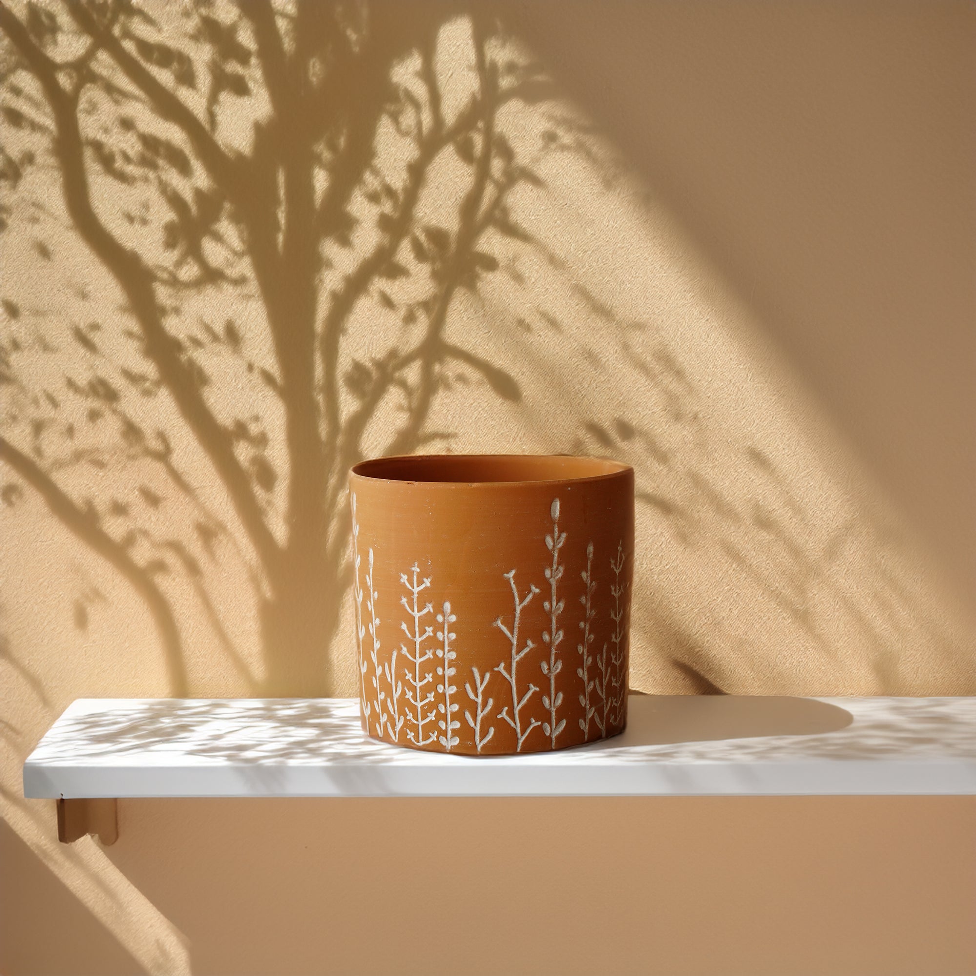 Terracotta Leafy Branch outdoor and indoor planter box by BEACON, perfect for displaying plants indoors or outside