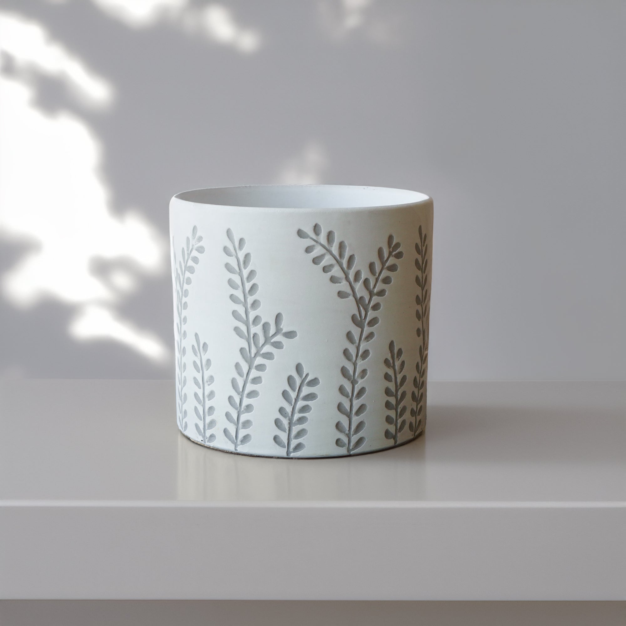 Outdoor and indoor leafy branch design planter box by BEACON, made of durable material for versatile garden or home use.