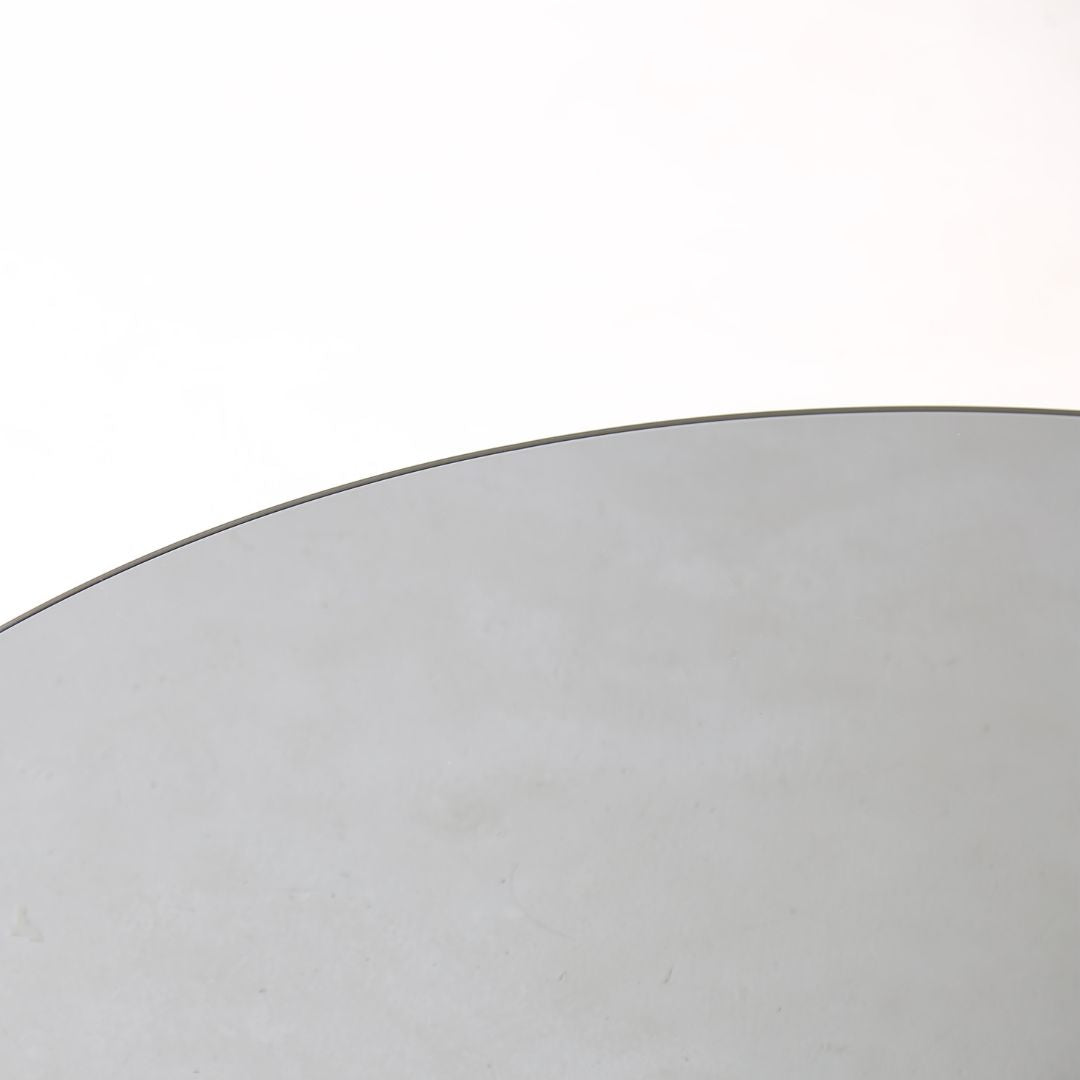 Minimal grey glass and travertine marble round coffee table by BEACON, showcasing a sleek modern design.