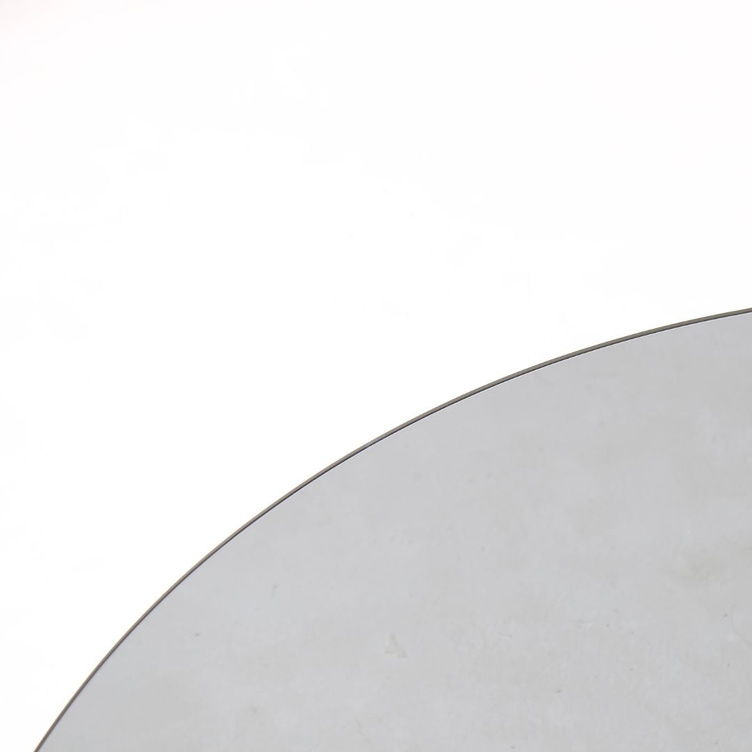 Minimal grey glass and travertine marble round coffee table by BEACON, modern design with sleek surface and sturdy base.