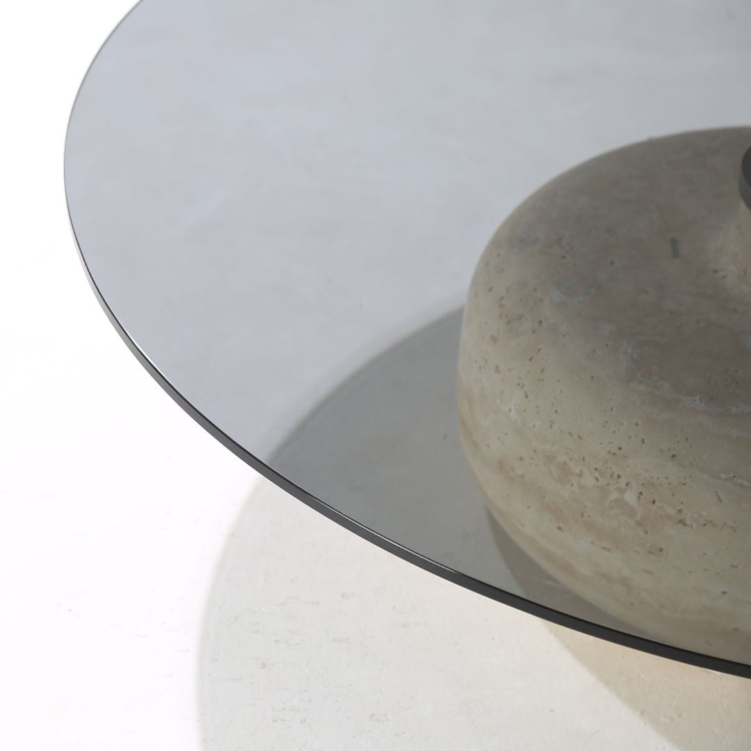 Minimal grey glass and travertine marble round coffee table by BEACON, modern design with sleek surface and stylish base.