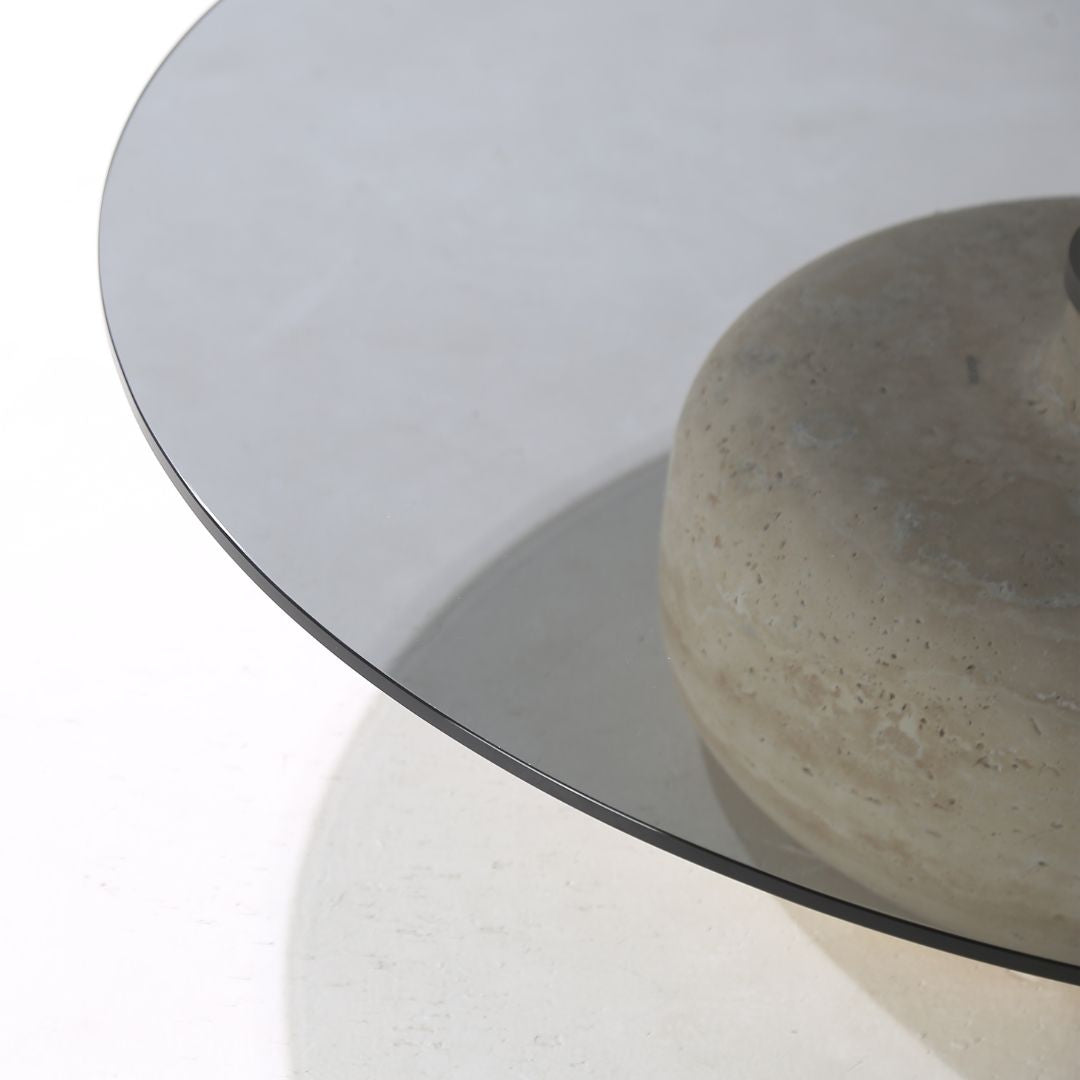 Minimal grey glass and travertine marble round coffee table by BEACON, showcasing sleek design and modern style.