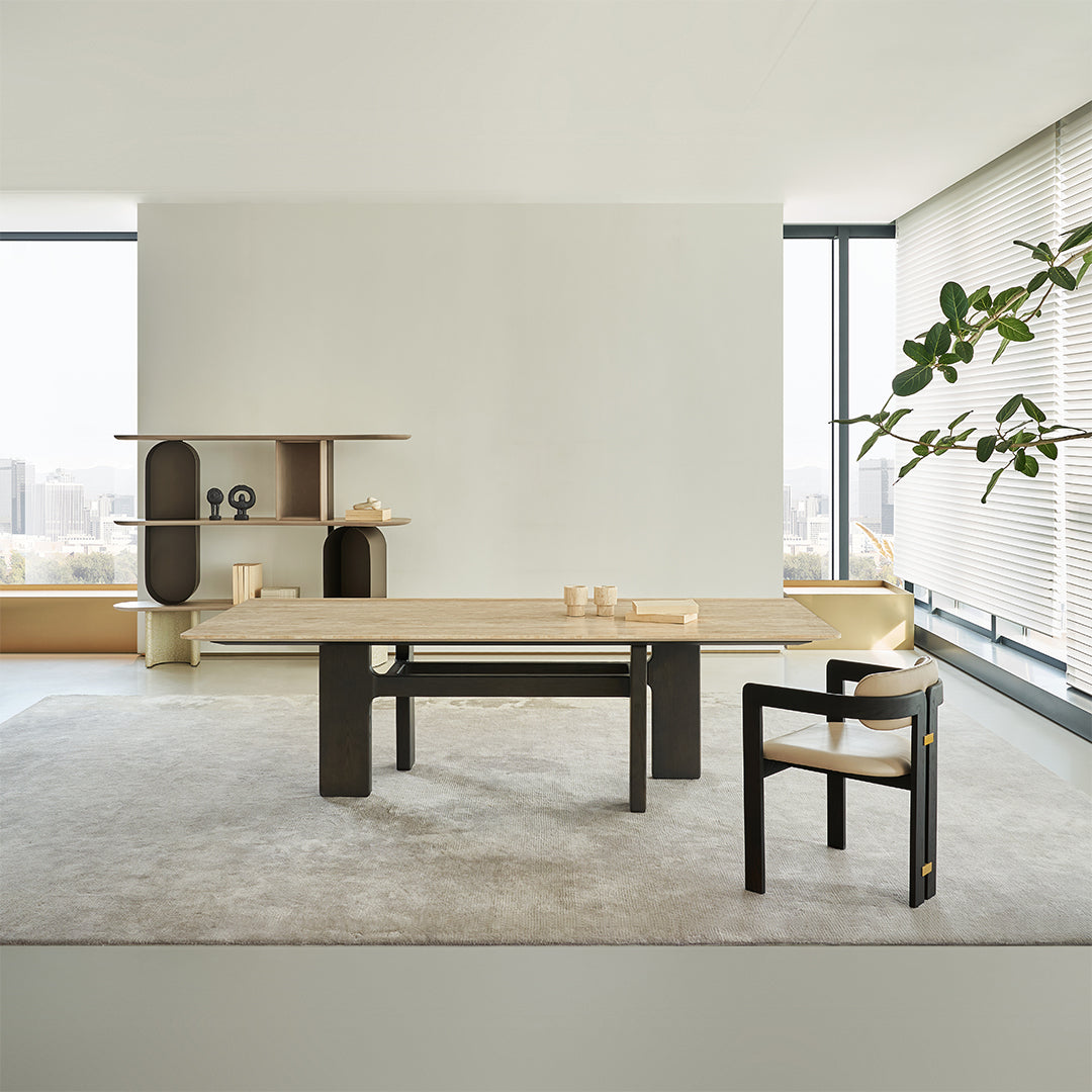 Miya Travertine Dining Table by BEACON featuring a sleek, modern design with a travertine tabletop and sturdy legs.