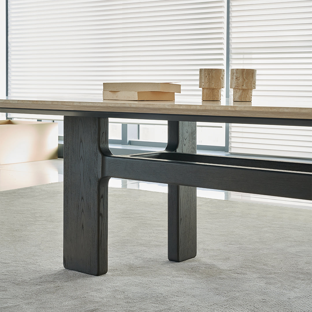 Miya Travertine Dining Table by BEACON with a sleek stone top and modern wooden legs, perfect for contemporary dining rooms.