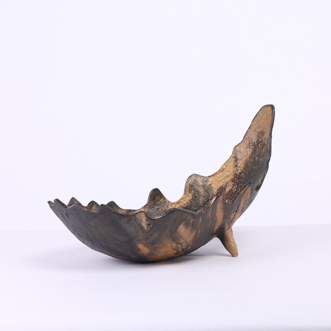 Moon-shaped metal tray by BEACON, sleek silver tray ideal for serving or decorative display with modern design.