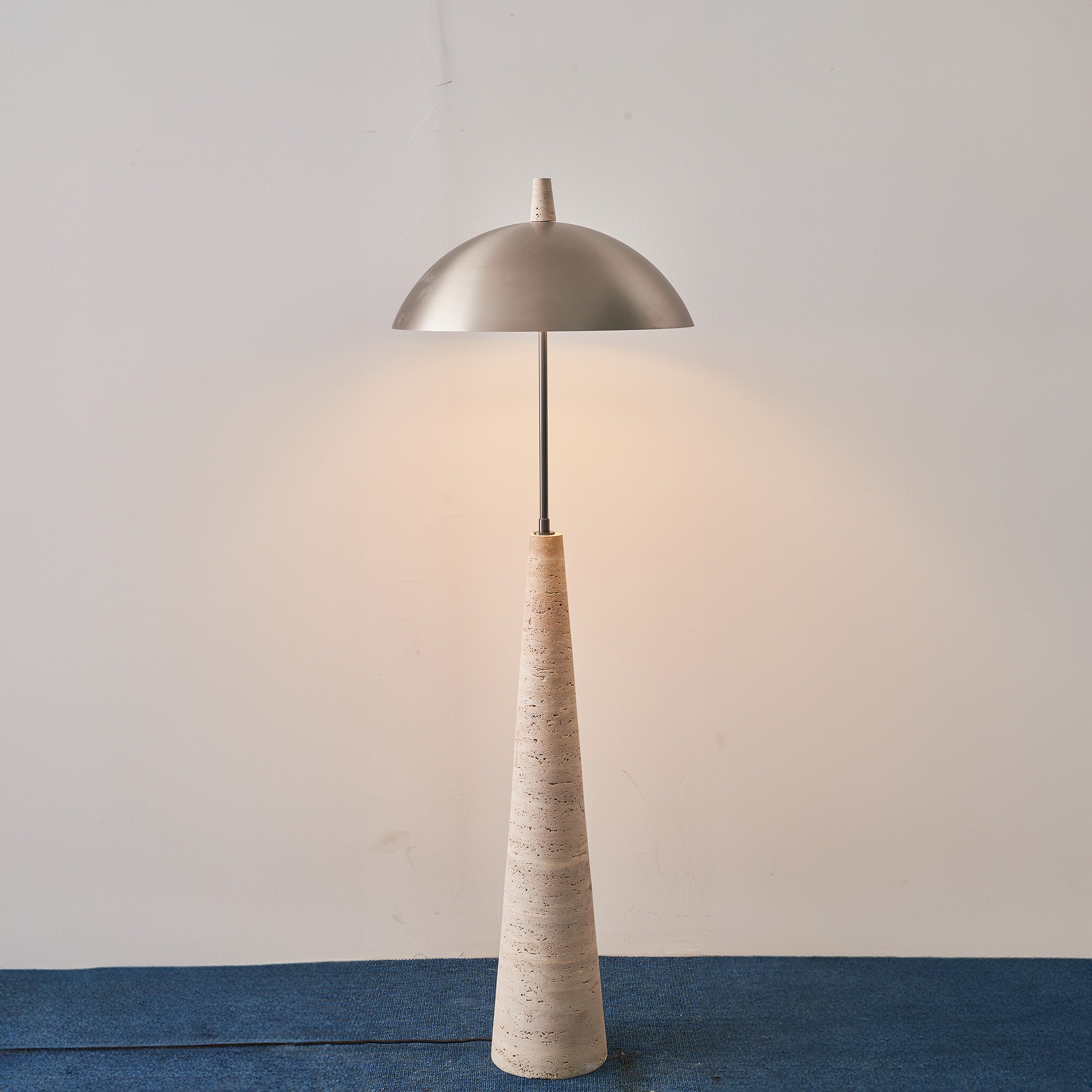 Natural travertine floor lamp by BEACON (JIADG), model JA-015F, showcasing a sleek, elegant design with a sturdy base and warm lighting.