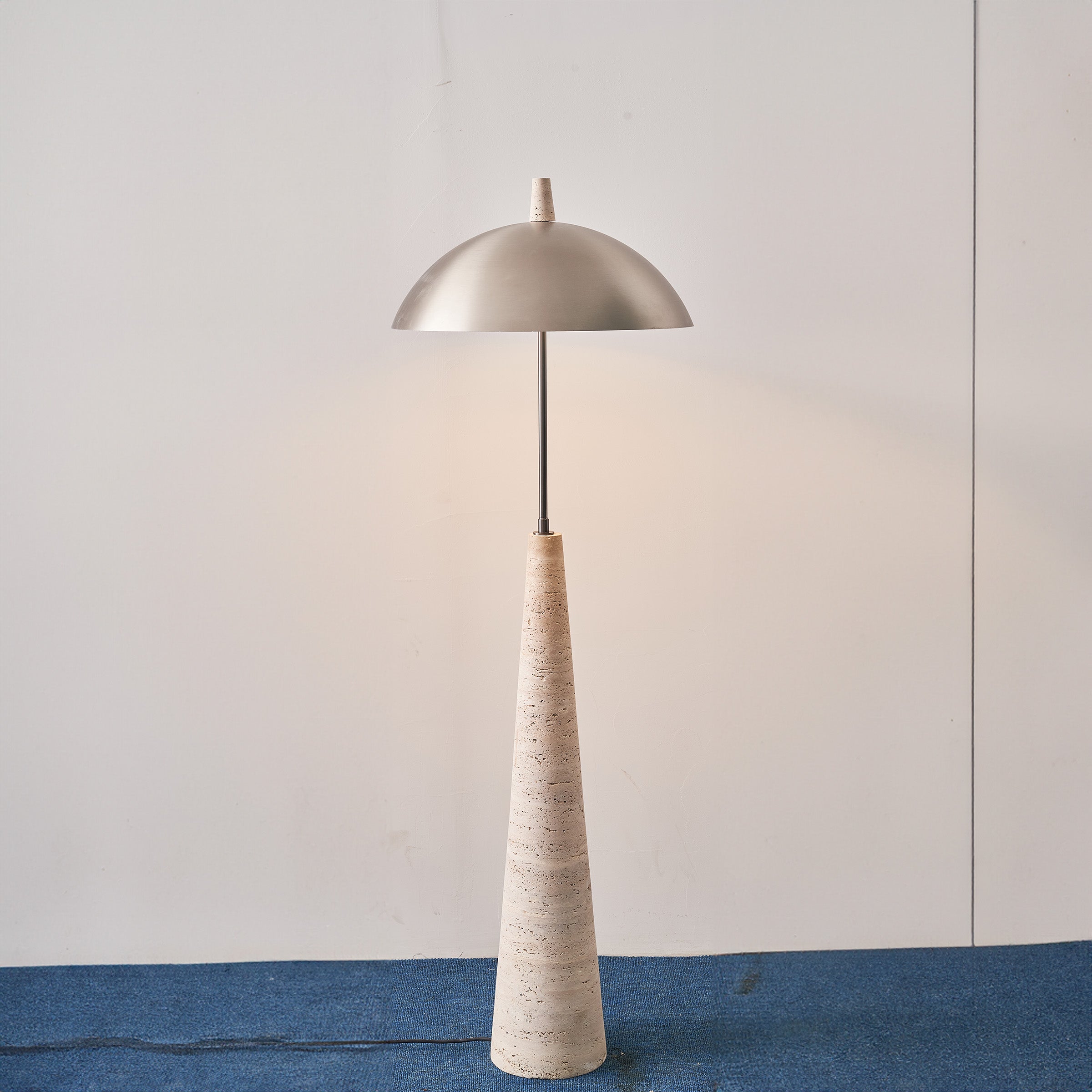 Natural travertine floor lamp with a sleek design from BEACON, model JA-015F, shown standing in a modern living space.