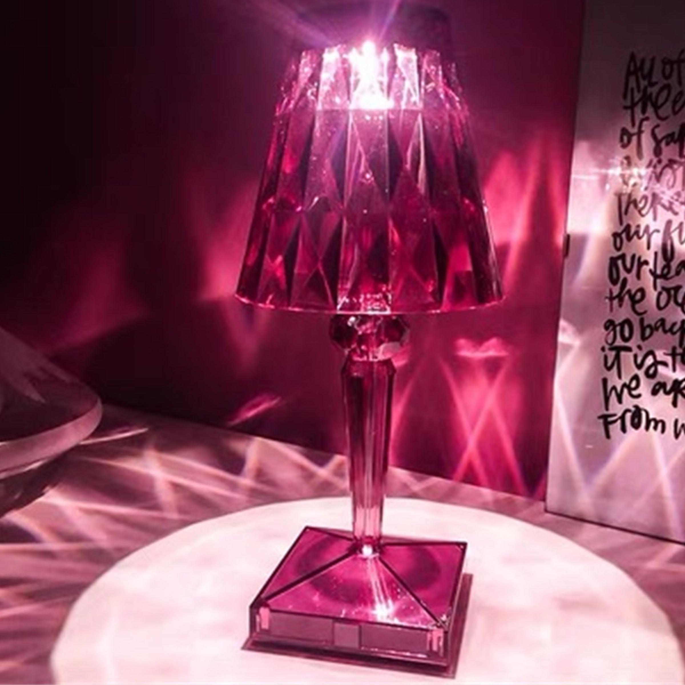 Purple BEACON night light table lamp on a desk, with a sleek design and soft purple glow for ambient lighting.