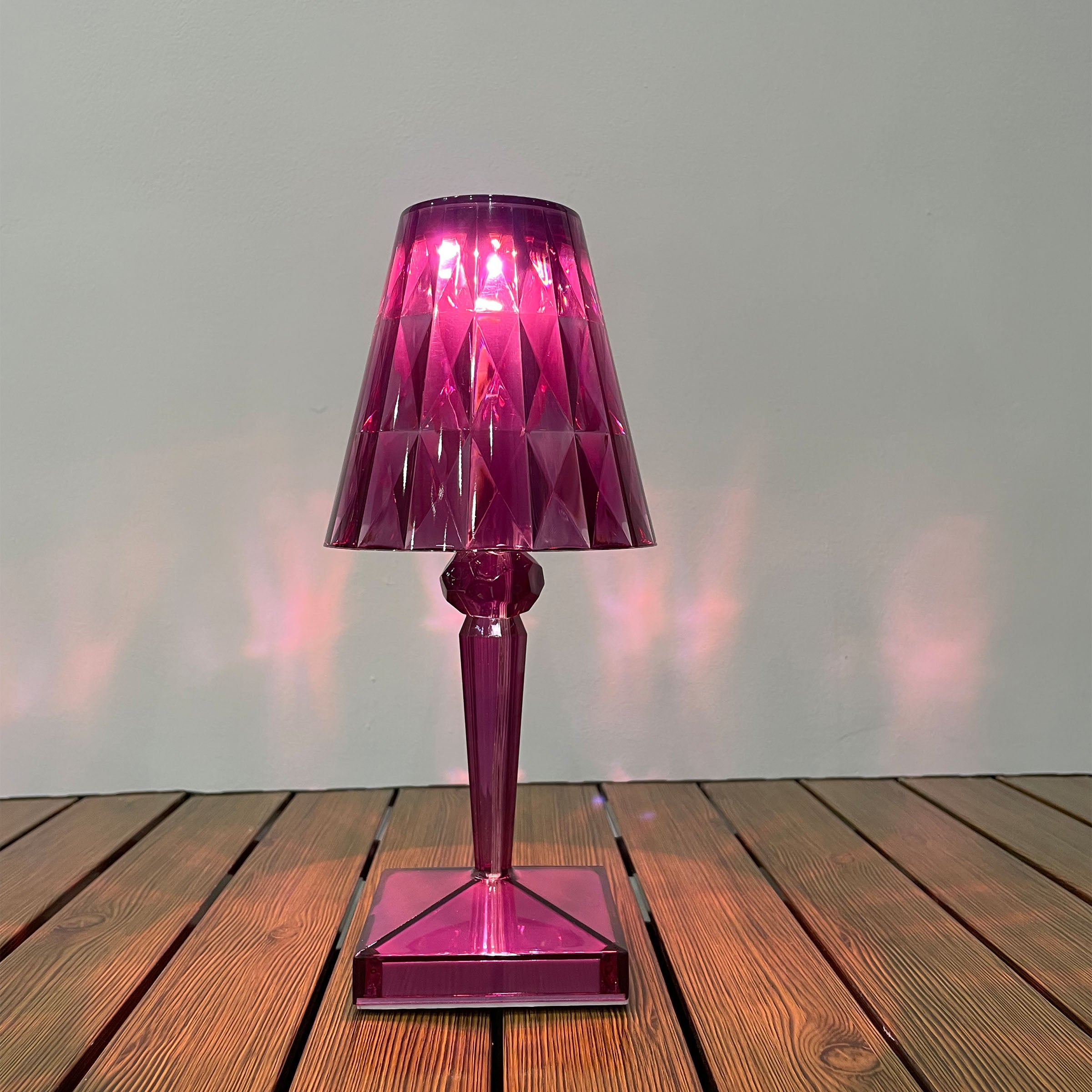 Purple BEACON night light table lamp on a desk, featuring a sleek design and soft purple glow for ambient lighting.